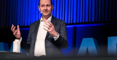 Bent Jensen, EVP and Divisional CEO of Commercial Building Services at Grundfos, speaking at a conference.