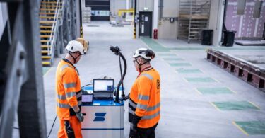Engineers operating Element’s mobile SIFT-MS emissions monitoring unit inside an industrial facility.
