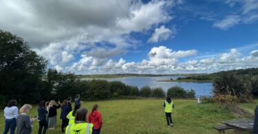 Drone flying over a reservoir monitoring algal blooms for water quality research