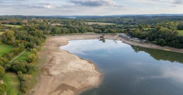 Aerial view of Ardingly Reservoir in Sussex showing low water levels during October 2025.