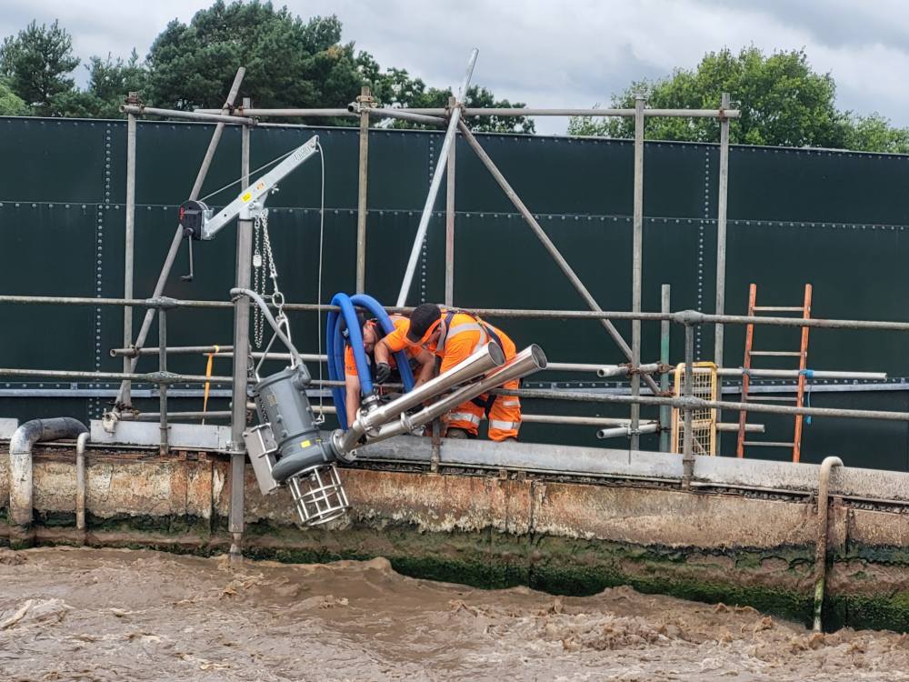 Engineers fit a Landia chopper pump system at a treatment plant, showcasing hands-on wastewater management training.