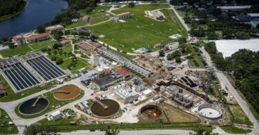 Aerial view of the David L. Tippin Water Treatment Facility showing treatment basins, tanks and new construction areas.