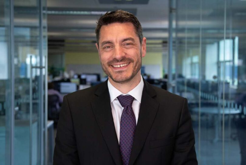 Portrait of James Jesic, incoming CEO of Severn Trent, standing in an office environment.