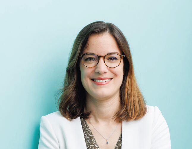 Portrait of Morgane Pigeaux, newly appointed Managing Director of HydroThane, smiling and wearing glasses and a white blazer.