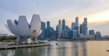 Urban waterfront and skyline in Southeast Asia, representing drinking water infrastructure and treatment systems.