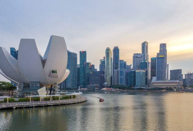 Urban waterfront and skyline in Southeast Asia, representing drinking water infrastructure and treatment systems.