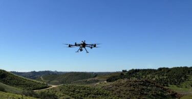 Drone flying over agricultural landscape capturing water intelligence data