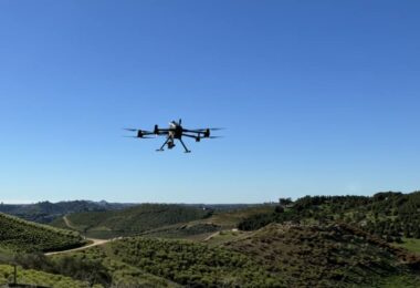 Drone flying over agricultural landscape capturing water intelligence data