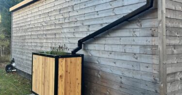Sustainable drainage planter connected to building roof downpipe in Edinburgh SuDS pilot