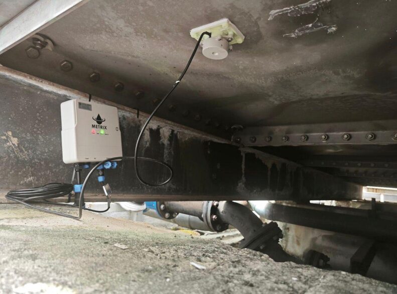 smart water tank monitoring technology non invasive sensor installed beneath water storage tank