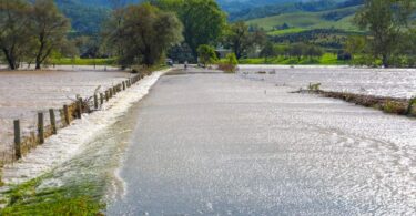 AI flood risk management flooding road overtopped by water during heavy rainfall