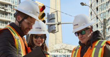 Engineers planning water infrastructure expansion project in urban construction environment