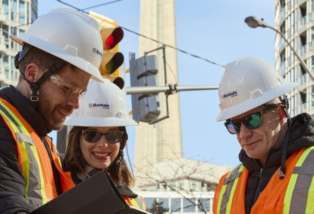 Engineers planning water infrastructure expansion project in urban construction environment