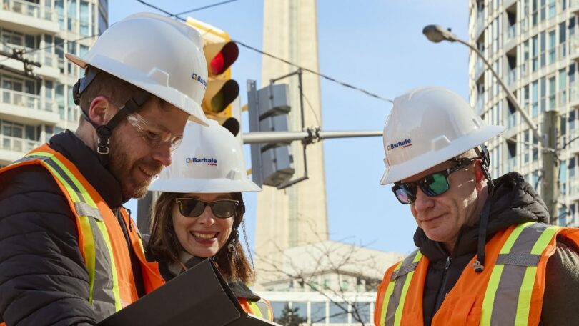 Engineers planning water infrastructure expansion project in urban construction environment