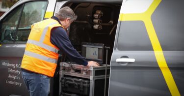 Engineer using Ovarro telemetry equipment in a service van for remote water infrastructure monitoring