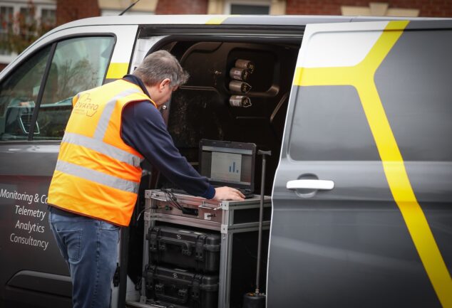 Engineer using Ovarro telemetry equipment in a service van for remote water infrastructure monitoring