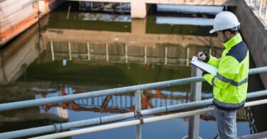 Engineer inspecting water infrastructure at a treatment site