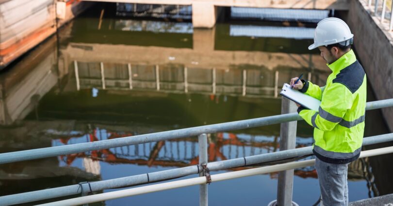 Engineer inspecting water infrastructure at a treatment site