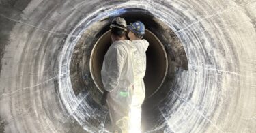 Technicians installing carbon fibre reinforced polymer liner inside Montréal water transmission main rehabilitation project
