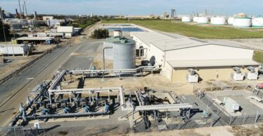 Aerial view of the Kwinana Water Reclamation Plant in Western Australia, showing treatment tanks and pipework within the Kwinana industrial area