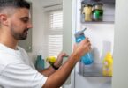 A bottle of chilled drinking water in a fridge, illustrating an appeal to use water for essential purposes during a heatwave