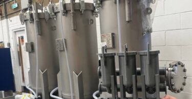 Containerised water filtration skid and scale model displayed by Amazon Filters for rapid drinking water treatment applications