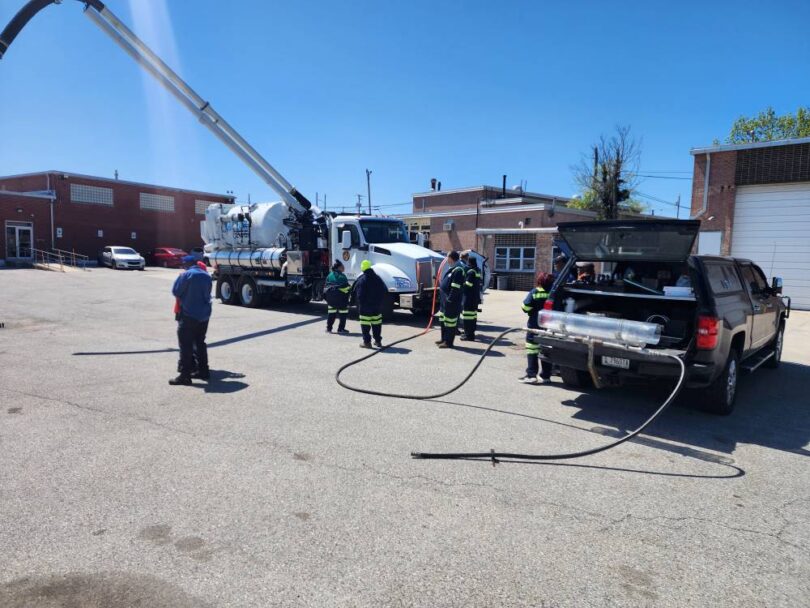 Wastewater operators attending an onsite sewer nozzle demonstration with jetting equipment