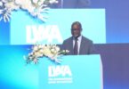 Kizito Masinde speaking at an International Water Association podium