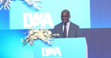 Kizito Masinde speaking at an International Water Association podium