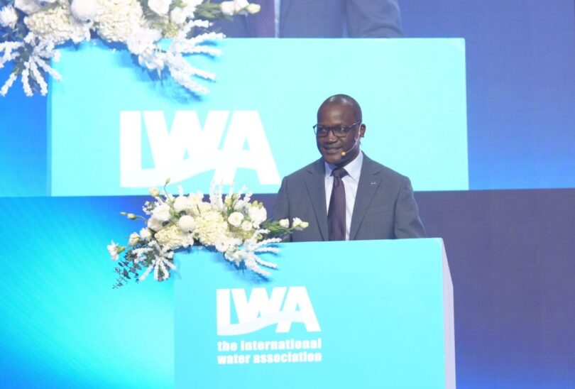 Kizito Masinde speaking at an International Water Association podium