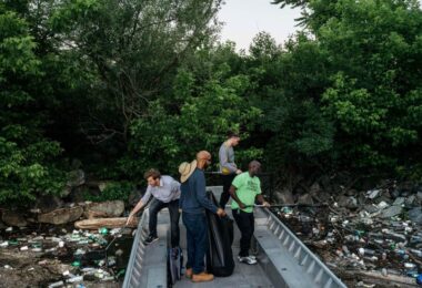 People inspecting a storm drain and polluted waterway as part of a smart watershed discussion