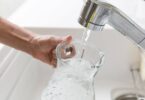 Tap water running into a glass jug during hot weather