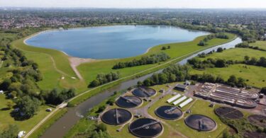 Aerial view of Esher Sewage Treatment Works and reservoir in the Thames Water region