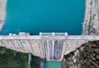 Aerial view of a dam and reservoir used to represent water infrastructure monitoring