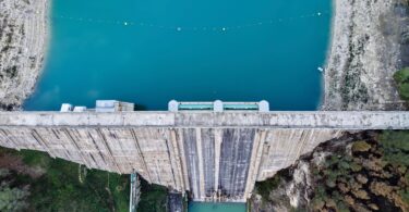 Aerial view of a dam and reservoir used to represent water infrastructure monitoring