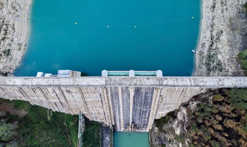 Aerial view of a dam and reservoir used to represent water infrastructure monitoring