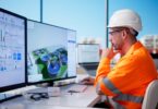 Water professional reviewing digital treatment plant data on multiple screens