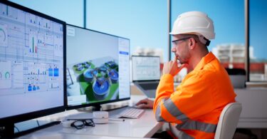 Water professional reviewing digital treatment plant data on multiple screens