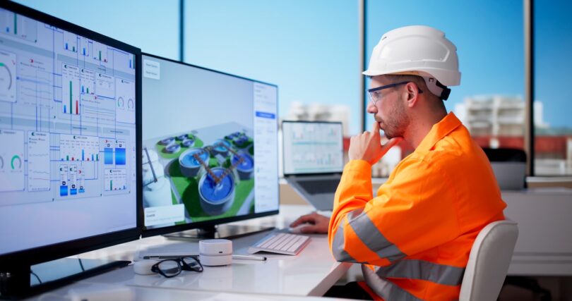 Water professional reviewing digital treatment plant data on multiple screens