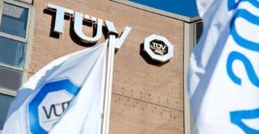 TÜV SÜD building with branded flags outside