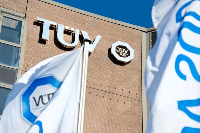 T&Uuml;V S&Uuml;D building with branded flags outside