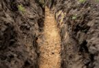 Freshly excavated trench prepared for underground utility installation before pipeline works
