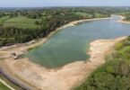 Aerial view of low water levels and exposed banks at Ardingly Reservoir in Sussex