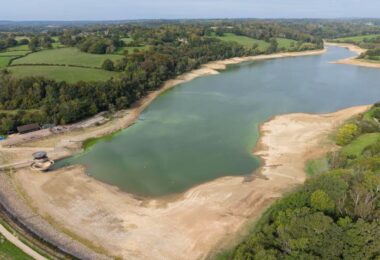 Aerial view of low water levels and exposed banks at Ardingly Reservoir in Sussex