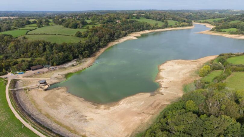 Aerial view of low water levels and exposed banks at Ardingly Reservoir in Sussex
