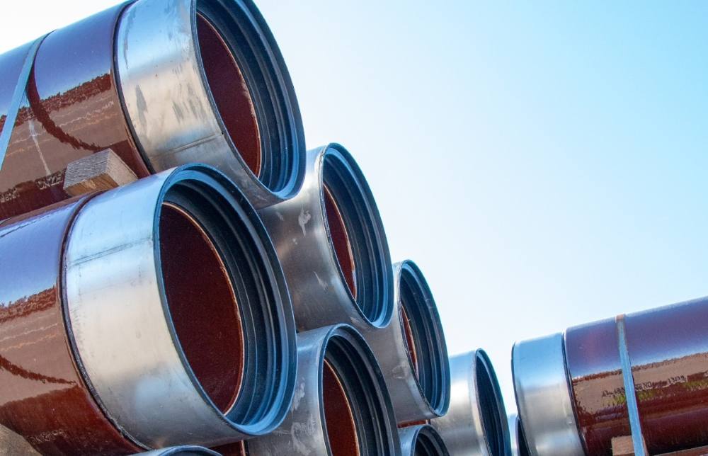 Stacked vitrified clay sewer pipes showing their circular openings and joint connections