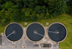 Aerial view of a sewage and wastewater treatment works in the UK, showing tanks and site infrastructure.