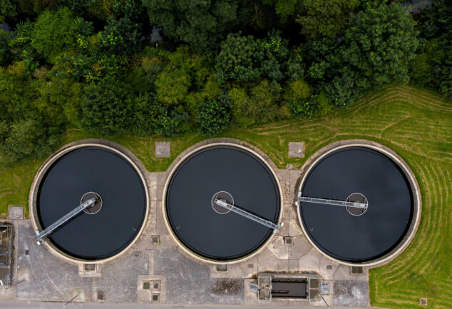 Aerial view of a sewage and wastewater treatment works in the UK, showing tanks and site infrastructure.