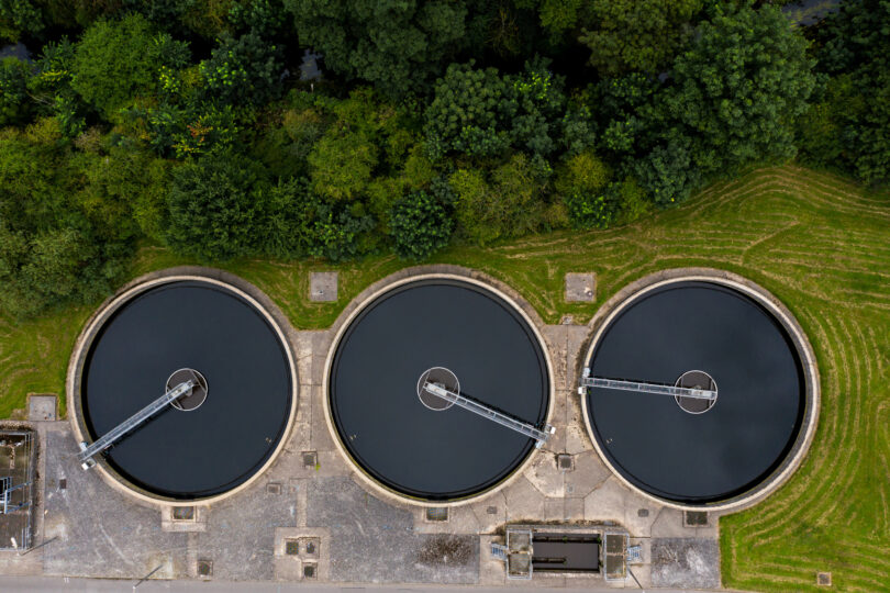 Aerial view of a sewage and wastewater treatment works in the UK, showing tanks and site infrastructure.