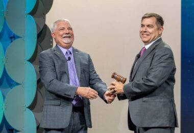 Paul Schuler receives the Water Environment Federation president's gavel from Keith Hobson